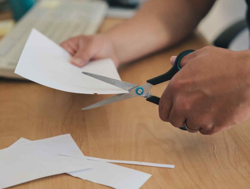 cutting paper with scissors 